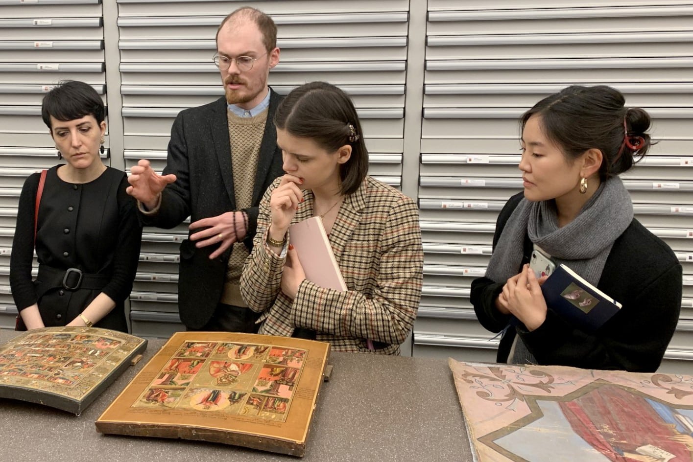 A group of people looking intently at two icons