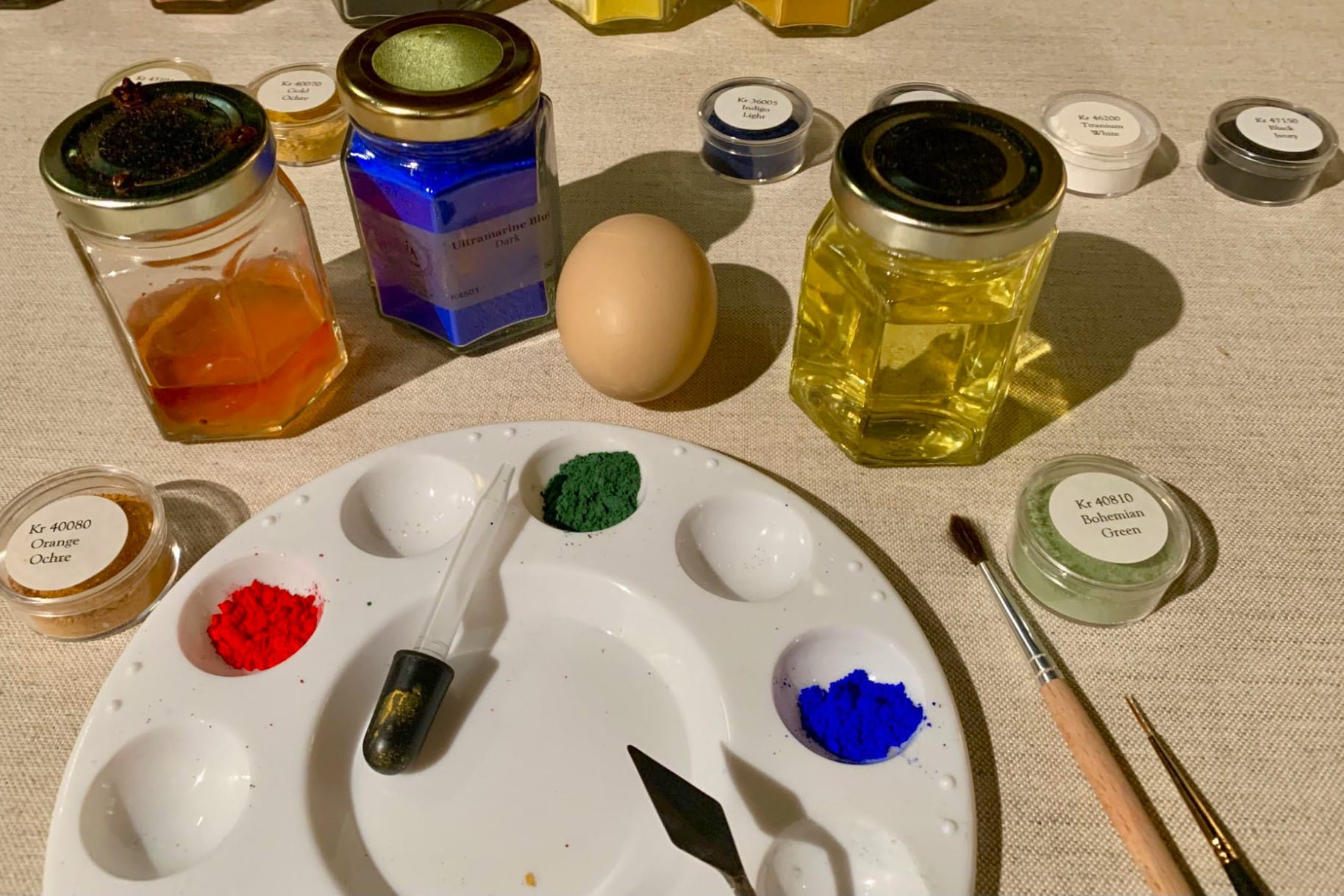 materials and pigments for egg tempera painting laid out on a table